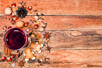 Christmas hot mulled wine with spices and cookies on a wooden background. Holiday food. Text space. Top view.