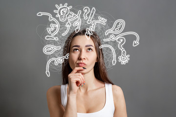 The concept of searching for ideas and information. Portrait of a pensive young Caucasian woman...