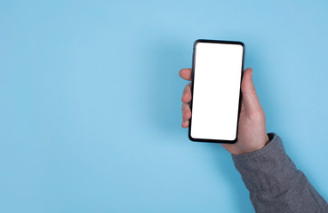 Phone in a man's hand. Blue background. Mockup of the phone.
