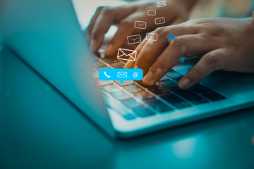 Contact us or Customer support hotline people connect. Businessman using a laptop computer with the...