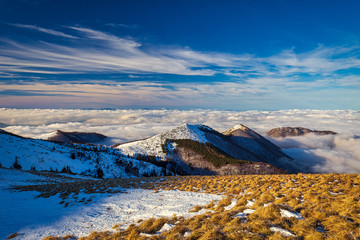 Winter mountain landscape at a sunny day with fog in the valleys. The Mala Fatra national park in Slovakia, Europe.