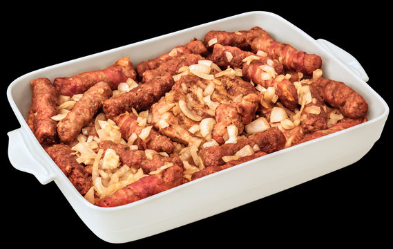 Barbecued Mixed Meat Loaves and Chicken Thighs Served with Chopped Onion in White Casserole Dish Isolated on Black Background