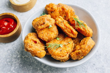 Fried crispy chicken nuggets with french fries and ketchup on light gray background. Seletive focus