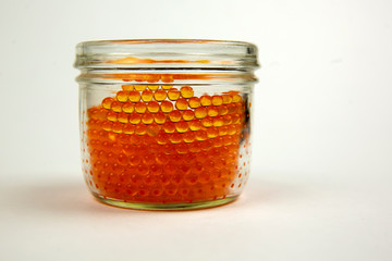 Red caviar in a jar in a white background