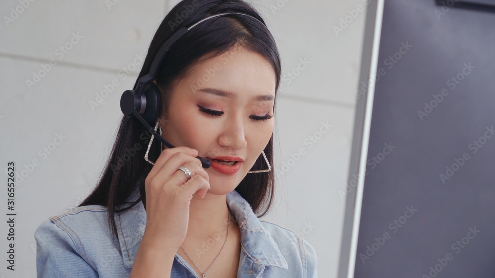 Aufkleber customer support agent or call center with headset works on desktop computer while supporting the cu