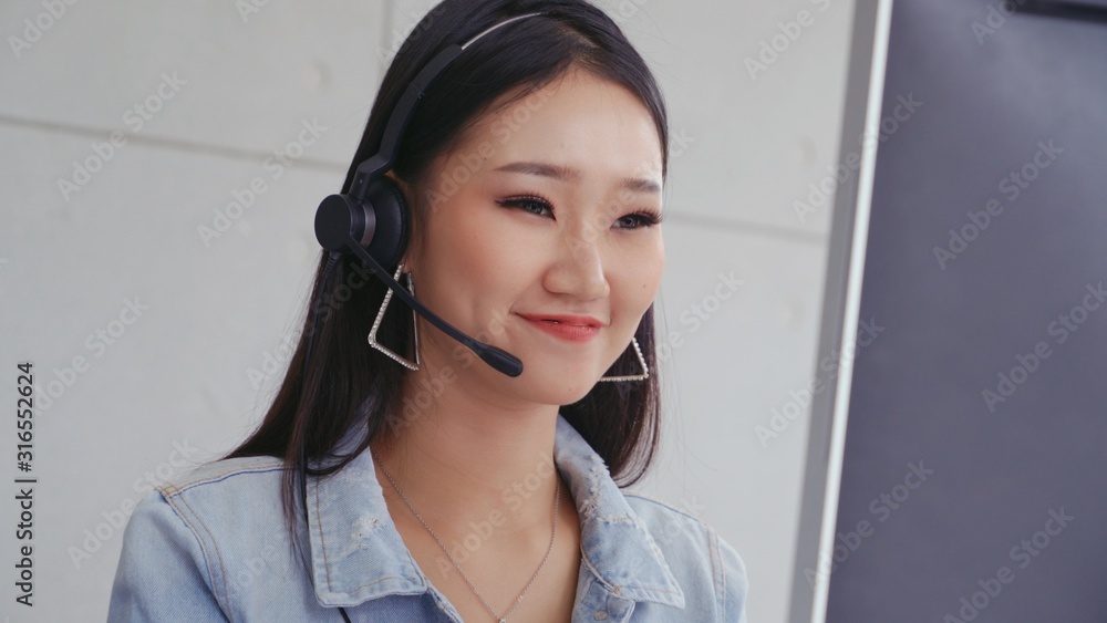 Aufkleber customer support agent or call center with headset works on desktop computer while supporting the cu
