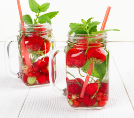 Fresh cool drink of ripe juicy cherry, strawberry, currant and gooseberry berries