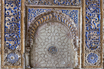 Seville, Spain; January 17, 2020: Detail of moorish carvings on the walls and arches of the Royal Alcazar. Closeup.