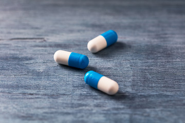 Creatine capsules on rustic wooden background. Concept for Sport nutrition. Close up. Copy space. 