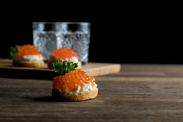 Russian Vodka, two shots of vodka with Caviar and Dark beard on black background, close up