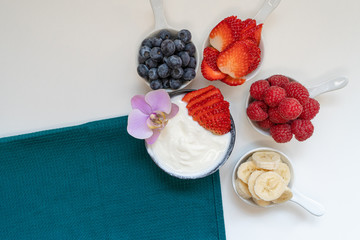 Greek yogurt in bowl with spoons,Healthy breakfast with Fresh greek yogurt, muesli and berries on background