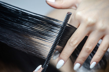 Woman cutting her long hair.