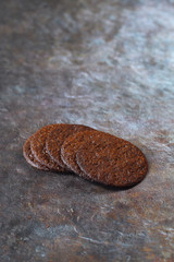 Thin and Crispy, Round Chocolate Cookies, dark background.