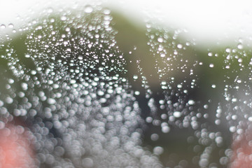 Blurred, raindrops, perched on a glass after a rain background image