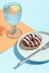 Various sweets, doughnuts, bagels, muffins and drinks on a multi-colored background. Bright colors, the concept of the holiday.