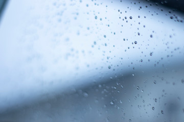 Blurred, raindrops, perched on a glass after a rain background image