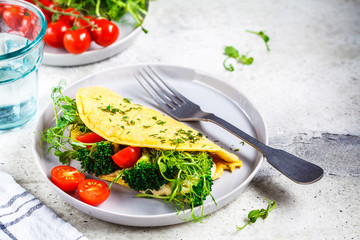 Vegan chickpea omelet with broccoli, tomatoes and seedlings. Healthy vegan food concept.