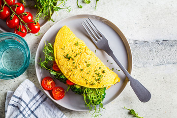 Vegan chickpea omelet with broccoli, tomatoes and seedlings, top view. Healthy vegan food concept.