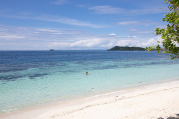 woman swimming in a beautiful tropical bay