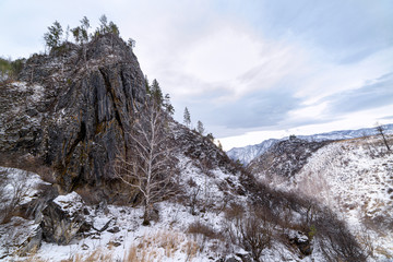Altai mountain gorge on a winter day, rocks covered with snow
