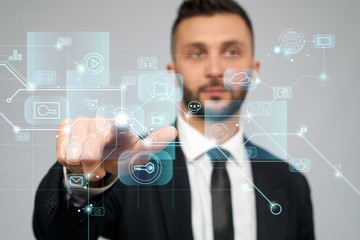 Smart businessman clicking virtual 3D icon.