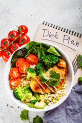 Diet plan concept. Chicken, broccoli and quinoa salad in white bowl, gray background, top view.