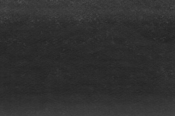 Cardboard black abstract texture close-up. Dark old paper background. Grunge concrete wall. Vintage blank wallpaper.