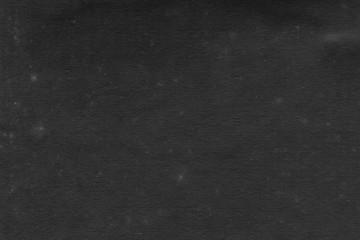 Cardboard black abstract texture close-up. Dark old paper background. Grunge concrete wall. Vintage blank wallpaper.