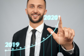 Young businessman touching virtual arrow.