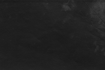 Fototapeta premium Cardboard black abstract texture close-up. Dark old paper background. Grunge concrete wall. Vintage blank wallpaper.