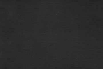 Cardboard black abstract texture close-up. Dark old paper background. Grunge concrete wall. Vintage blank wallpaper.