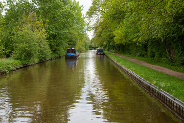 Scenic canal view with approaching narrowboat on the Llangollen Canal near Whitchurch, Shropshire, UK