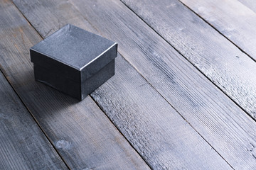 black gift box on dark wood table background