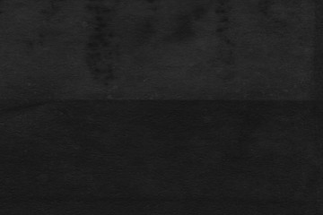 Cardboard black abstract texture close-up. Dark old paper background. Grunge concrete wall. Vintage blank wallpaper.