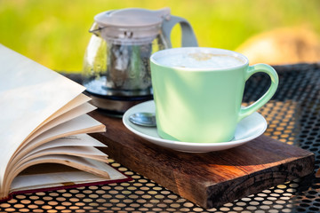 Cappuccino and Book at Outdoor Table