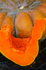 Colorful cut slice of orange pumpkins at a farmers market
