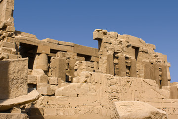 Karnak temple complex in Luxor, Egypt. Ruins of ancient temple with hieroglyphs on wall.
