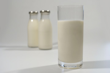 Milk in a glass on a gray background close-up. Milk product.