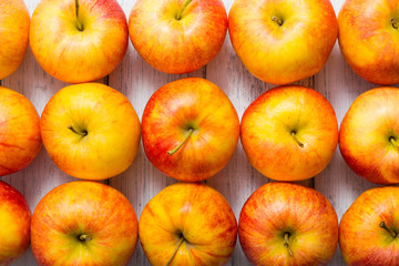 apple fruits in a row, white wooden table background
