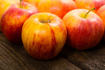 apple fruits in a row, old weathered wood table background