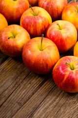 apple fruits in a row, old weathered wood table background