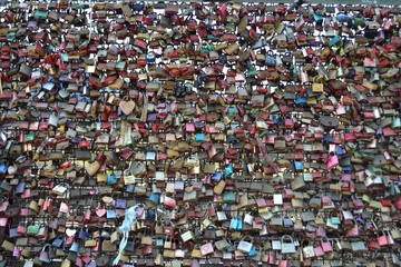Love locks at the Hohenzollern Bridge in Cologne. Couples symbolize their love by locking a padlock on bridge and throwing the key into the Rhine river.