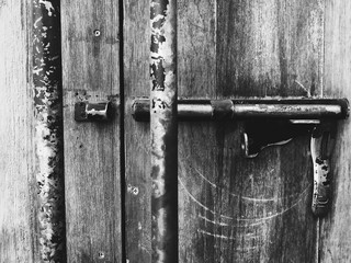 Door lock on wooden doors black and white style selective focus.