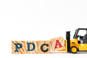 Toy forklift hold wood letter block a to complete word PDCA (Plan, Do, Check, Act) on white background