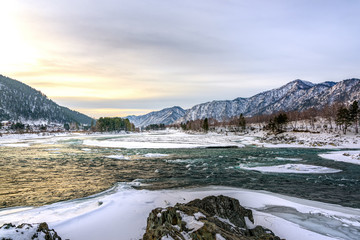 Landscape with snow-capped mountains and mountain river