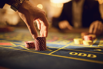 A player plays roulette in a casino.