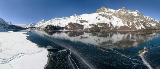 Aerial panorama image of the frozen lake of Silsersee - Maloja and Plaun da Lej in St. Moritz, Switzerland