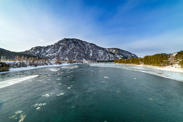 Landscape with snow-capped mountains and mountain river