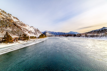 Landscape with snow-capped mountains and mountain river
