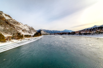 Landscape with snow-capped mountains and mountain river